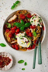 Chicken spaghetti with burrata cheese ,cherry tomatoes and lemon butter  garlic sauce.top veiw .