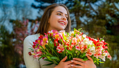Woman with bouquet of flowers. Spring holiday concept. Girl, flowers, spring, outdoors. Spring...