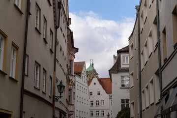 A narrow alleyway with a tall building in the background
