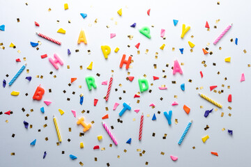 Creative composition made with birthday party things and party streamers on white background. Minimal celebration party concept.