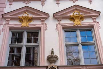 The building has two windows with gold trim