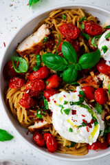 Chicken spaghetti with burrata cheese ,cherry tomatoes and lemon butter  garlic sauce.top veiw .