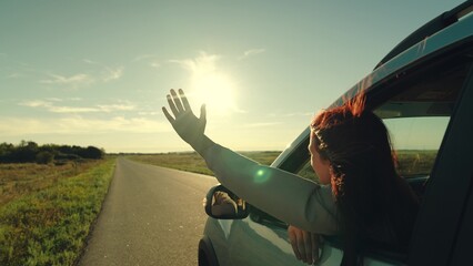 girl rides car with her hand out window, car road, windy breeze from window cars, during summer...