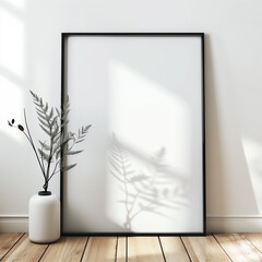 Black Frame Mockup Leaning on White Wall on Wooden Surface
