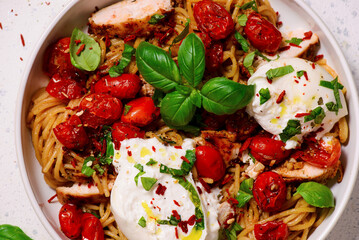 Chicken spaghetti with burrata cheese ,cherry tomatoes and lemon butter  garlic sauce.top veiw .