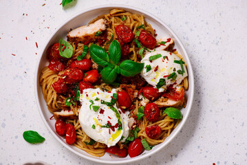 Chicken spaghetti with burrata cheese ,cherry tomatoes and lemon butter  garlic sauce.top veiw .