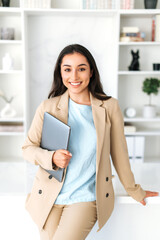 Vertical photo of successful arabian or indian young business woman in a suit, digital manager,...