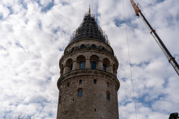 Fototapeta na wymiar A tall tower with a crane in the background