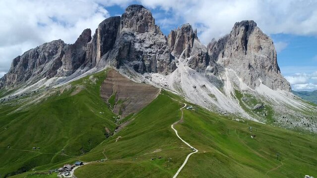 Aerial video of Sassolungo: Sassolungo (Langkofel in German, Saslonch in Ladin) is the main peak of the massif of the same name, located between Val Gardena and Val di Fassa. Dolomites, Italy