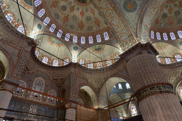 The inside of a building with a large dome and many windows