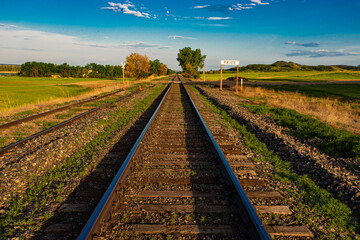 Railroad tracks leading into the vast green landscape of central North Dakota.