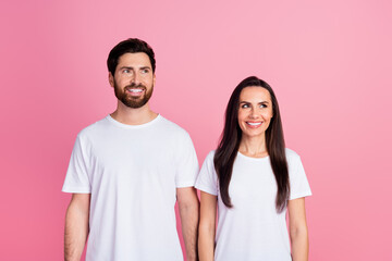 Fototapeta premium Photo portrait of lovely young couple look interested empty space dressed stylish white garment isolated on pink color background