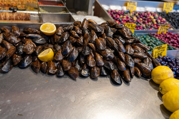 A table with a pile of mussels and lemons