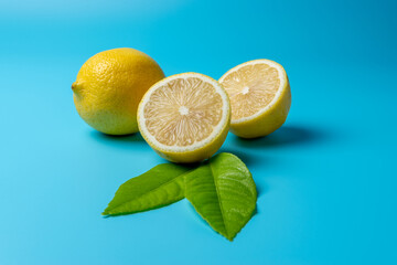 Fresh sliced lemon on blue background. Minimal food concept.