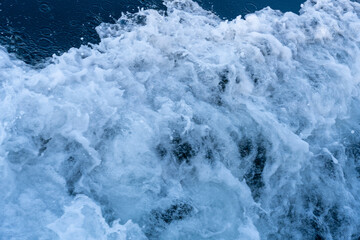 A large wave crashing into the shore