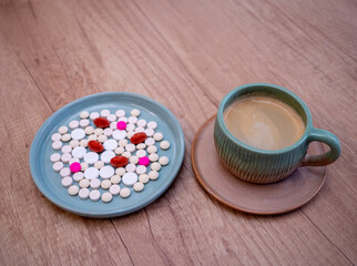 Obraz na płótnie Canvas Medicines and coffee are two common ingredients in many people's lives. But should some medications never be mixed with coffee?