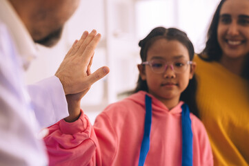 A young girl is being consulted and examined by a male doctor in the hospital.
