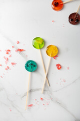  Top view of fruits pop candy lollipop on light surface