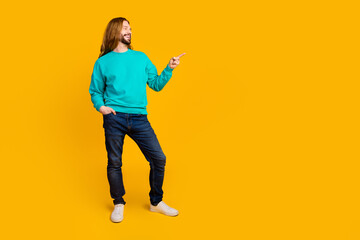 Fototapeta na wymiar Full body photo of positive young man look direct finger empty space ad isolated on yellow color background