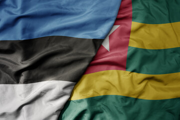 big waving national colorful flag of togo and national flag of estonia.