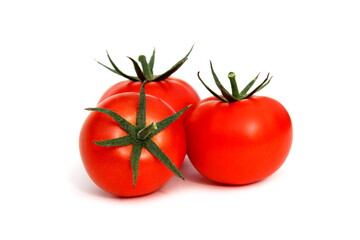 Three red tomatoes lie on a white background.	