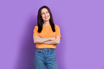 Portrait of folded arms specialist businesswoman in yellow t shirt looking empty space plan project isolated on violet color background