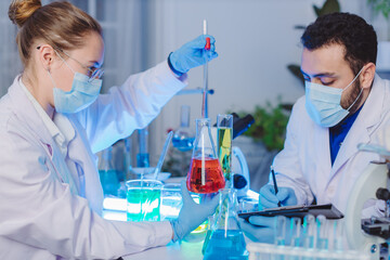 Scientist and people in science exam, test or group project in experiment or assignment at laboratory. Scientist or pharmacist work in scientific lab. Medical Development Laboratory.