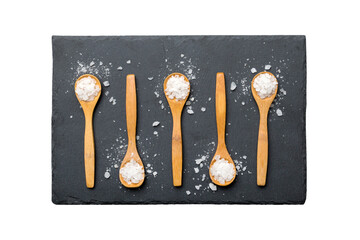 salt on many wooden spoon isolated on white background. Spoons with different salt