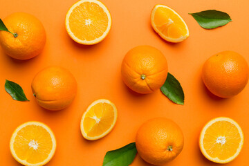 Fruit pattern of fresh orange slices on colored background. Top view. Copy Space. creative summer concept. Half of citrus in minimal flat lay