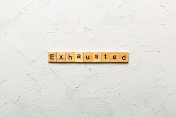 Exhausted word written on wood block. Exhausted text on cement table for your desing, concept