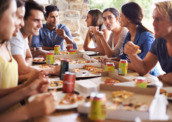 Friends, group and eating of pizza in house with happiness, soda and social gathering for bonding in backyard. Men, women and fast food with smile, drinks and diversity at table in lounge of home