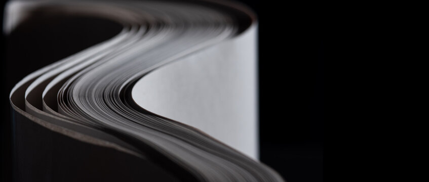 sheets white paper edge flow wave shape on black copy space empty background