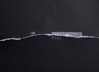 Torn black paper with transparent adhesive tape or strips,repair paper