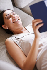 Woman, smile and relax on sofa with book, reading and learning with story and literature...