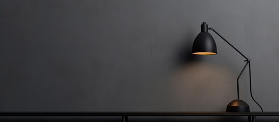 Black wall lamp against a gray backdrop