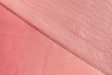 Luxurious fabrics, peach color, creative background, smooth and rough textures.