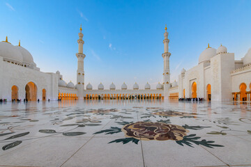 Interior courtyard of the Sheikh Zayed Grand Mosque, the largest mosque in the UAE, illuminated at...