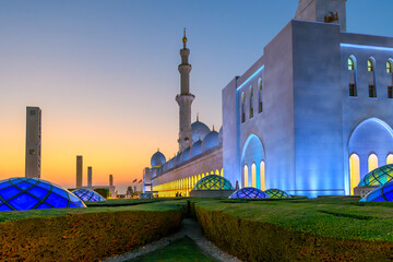 The Sheikh Zayed Grand Mosque, the largest mosque in the UAE, illuminated at sunset in Abu Dhabi,...