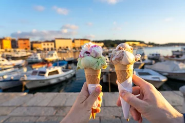 Fotobehang couple eating ice cream in Rovinj harbor with sunlight © Bernadett