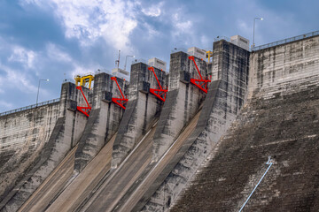 A large sluice gate blocks the water of Khun Dan Prakan Chon Dam. Beautiful large cement dam in Nakhon Nayok Province.