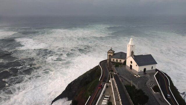 Hermitage of Nuestra Se&ntilde;ora de la Blanca in Luarca with the lighthouse and the Cantabrian sea in Asturias, Spain
