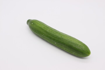 Image of a green long cucumber on a light background.