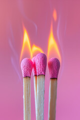 Wooden matchsticks burning on isolated pastel pink background. Minimal abstract creative concept of emotional, mental and physical burnout, mental health, stress symptoms.