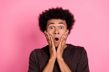 Closeup photo of young shocked wavy hair man touch cheeks amazed unbelievable moment in his life isolated on pink color background