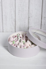 Marshmallow flowers. Marshmallows in the box. Homemade marshmallows. On white boards.