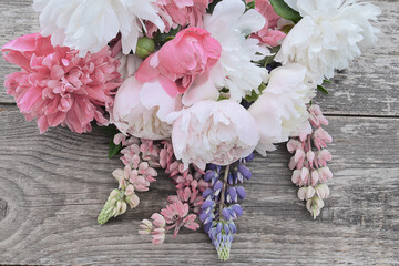 Bouquet of white and pink peonies with waterdrops on a rustic wooden backgroud; Wedding or birthday...