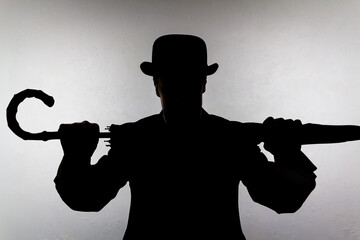 Silhouette of English Gentleman in Bowler Hat Holding Umbrella Like a Weapon. Vintage British Spy...