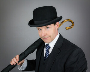 Portrait of Stylish English Gentleman in Suit and Bowler Hat. Vintage Style and Retro Fashion.