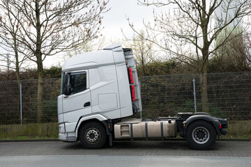 Gray car semi-trailer stands on the side of the road. Side view.