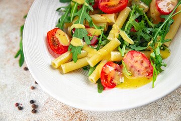 pasta salad tomato, arugula fresh food tasty eating cooking appetizer meal food snack on the table copy space food background rustic top view